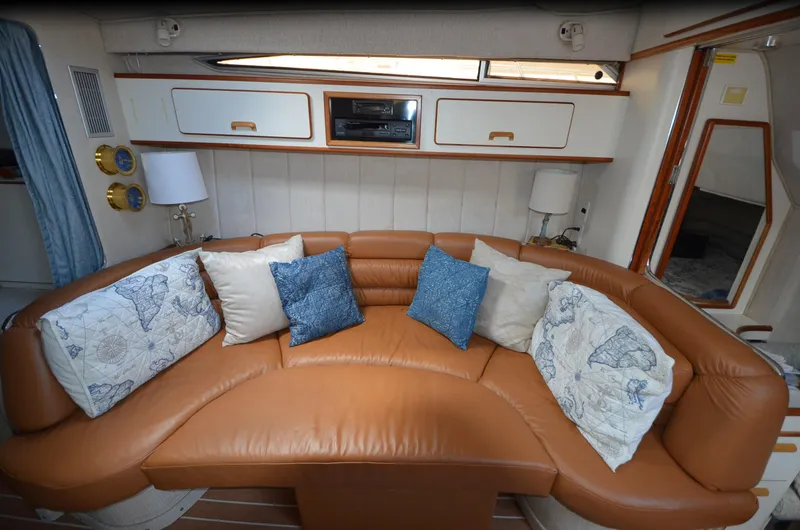 Slide: The Image of Luxurious interior of 1990 Sea Ray 350 Sundancer Coupe with leather seating and decorative pillows. - 20