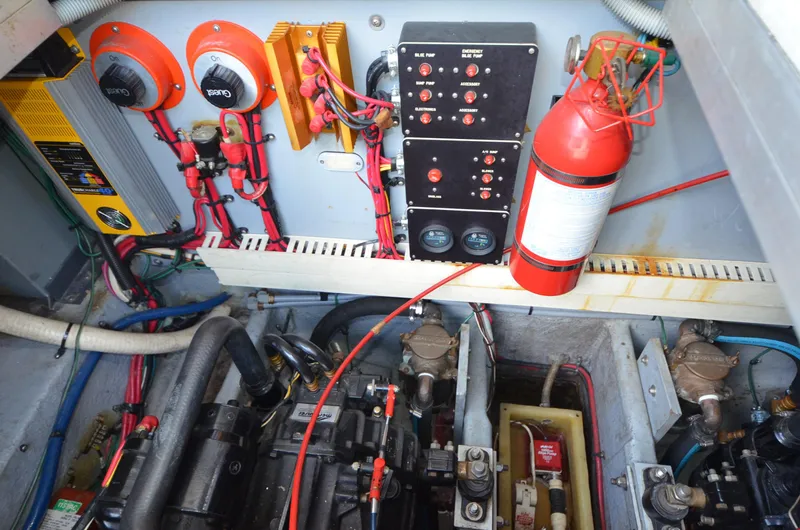 Slide: The Image of Engine room of 1990 Sea Ray 350 Sundancer Coupe with control panel and fire extinguisher. - 27