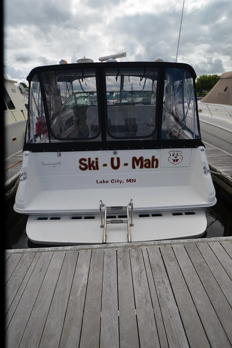 Slide: The Image of 1990 Sea Ray 350 Sundancer Coupe docked, rear view, "Ski-U-Mah" text, Lake City, MN. - 28