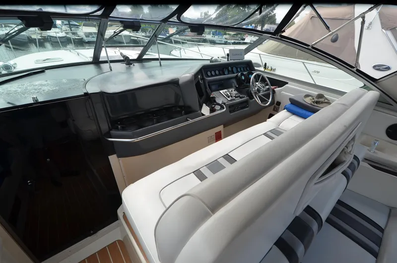 Slide: The Image of Cockpit of 1990 Sea Ray 350 Sundancer Coupe with steering wheel and control panel. - 8