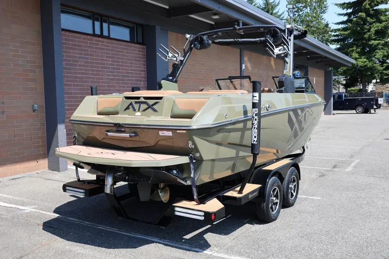 Slide: The Image of 2023 ATX Surf Boats 22 Type-S on trailer, parked outdoors near a brick building. - 14