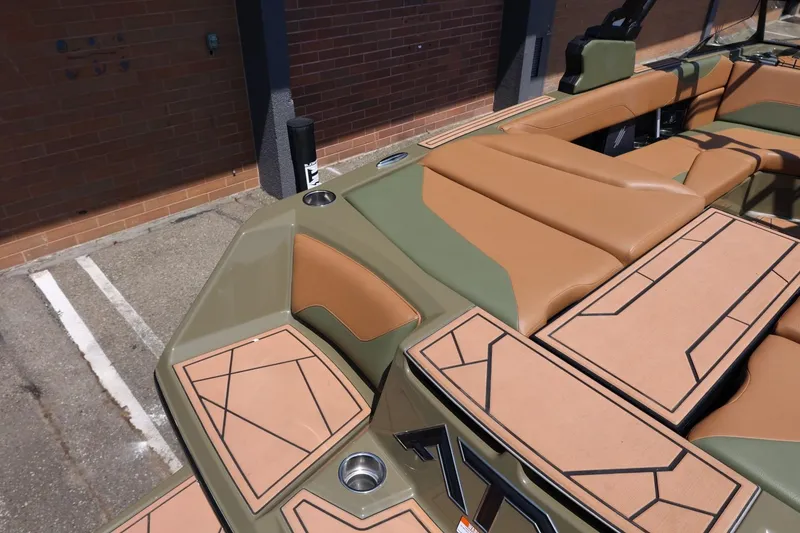 Slide: The Image of 2023 ATX Surf Boats 22 Type-S interior with tan and green upholstery, geometric design. - 19
