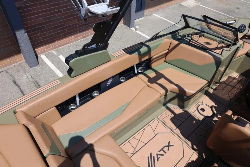 Slide: The Image of 2023 ATX Surf Boats 22 Type-S interior with tan and green seating, modern design. - 25