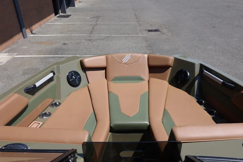 Slide: The Image of 2023 ATX Surf Boats 22 Type-S interior with tan and green seating, cup holders, and speakers. - 41