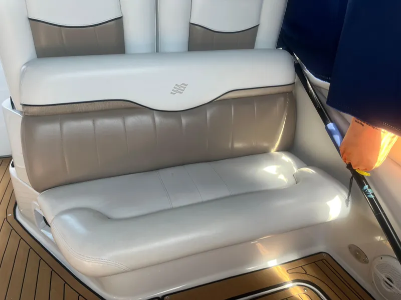 Slide: The Image of 2007 Four Winns 258 Vista boat interior with beige leather seating and wood flooring. - 10