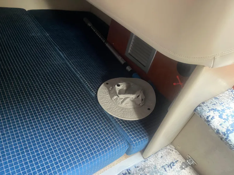 Slide: The Image of Interior of 2007 Four Winns 258 Vista boat with blue seating and a hat. - 12