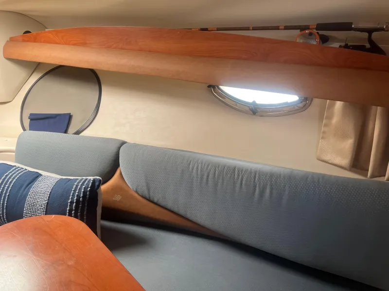 Slide: The Image of Interior of 2007 Four Winns 258 Vista boat with cozy seating and porthole window. - 14