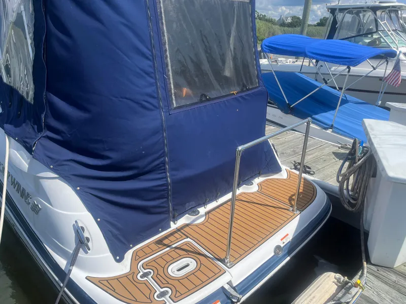 Slide: The Image of 2007 Four Winns 258 Vista boat with blue cover docked at marina. - 2