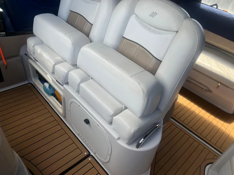 Slide: The Image of 2007 Four Winns 258 Vista boat interior with white cushioned seats and wood-patterned flooring. - 5