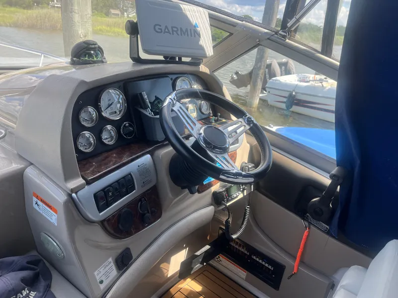 Slide: The Image of 2007 Four Winns 258 Vista boat dashboard with Garmin navigation system and steering wheel. - 8