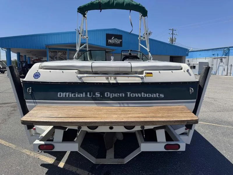 Slide: The Image of 1999 Malibu Sunsetter VLX boat labeled "Official U.S. Open Towboats" at a marina. - 12
