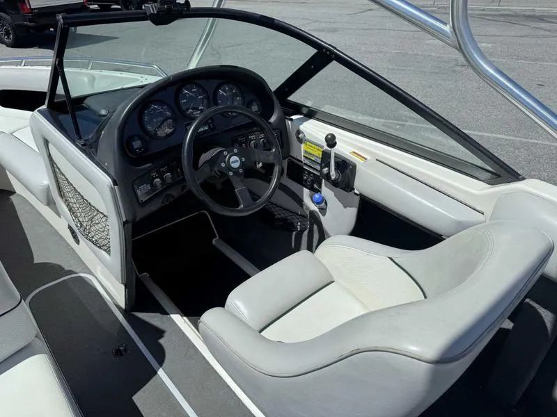 Slide: The Image of 1999 Malibu Sunsetter VLX boat interior with steering wheel and dashboard controls. - 13