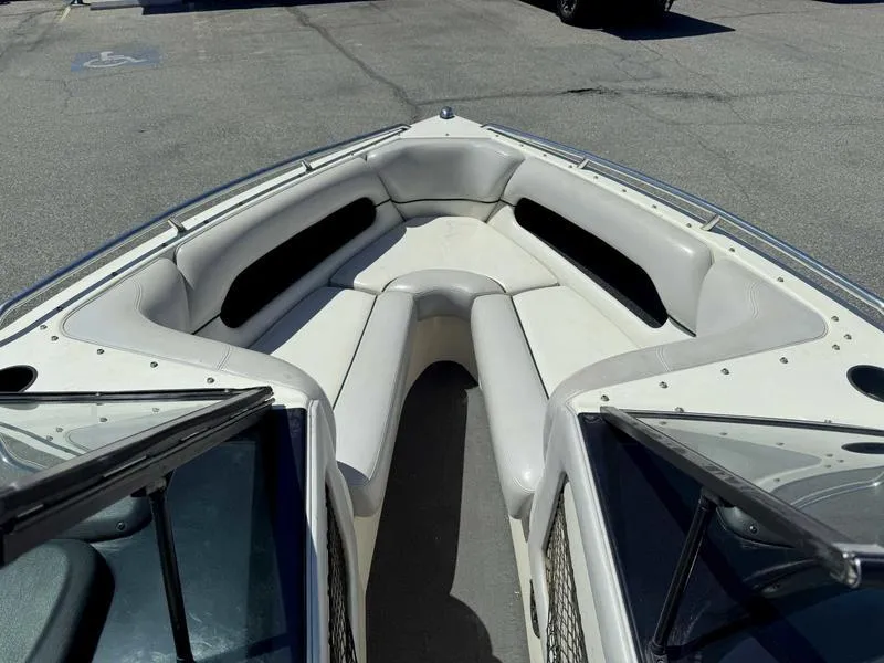 Slide: The Image of 1999 Malibu Sunsetter VLX boat interior with white cushioned seating. - 14