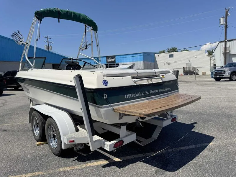 Slide: The Image of 1999 Malibu Sunsetter VLX boat on trailer in parking lot, featuring "Official U.S. Open Towboats" text. - 5