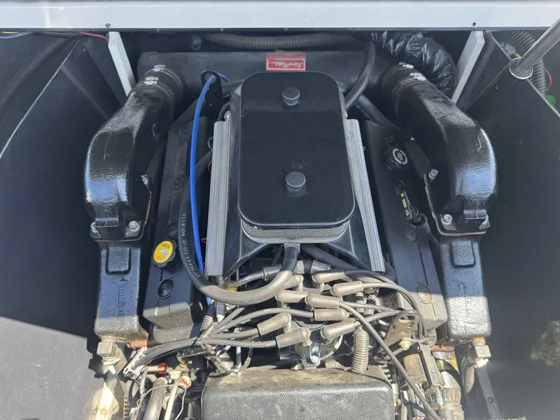 Slide: The Image of 1999 Malibu Sunsetter VLX engine compartment with visible components and wiring. - 6