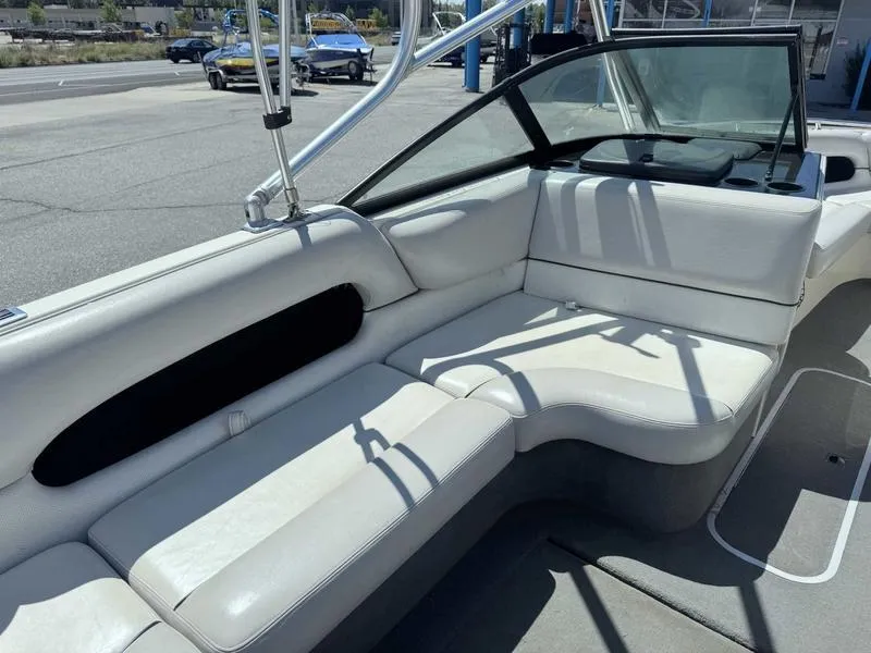 Slide: The Image of 1999 Malibu Sunsetter VLX boat interior with white seating and windshield. - 7