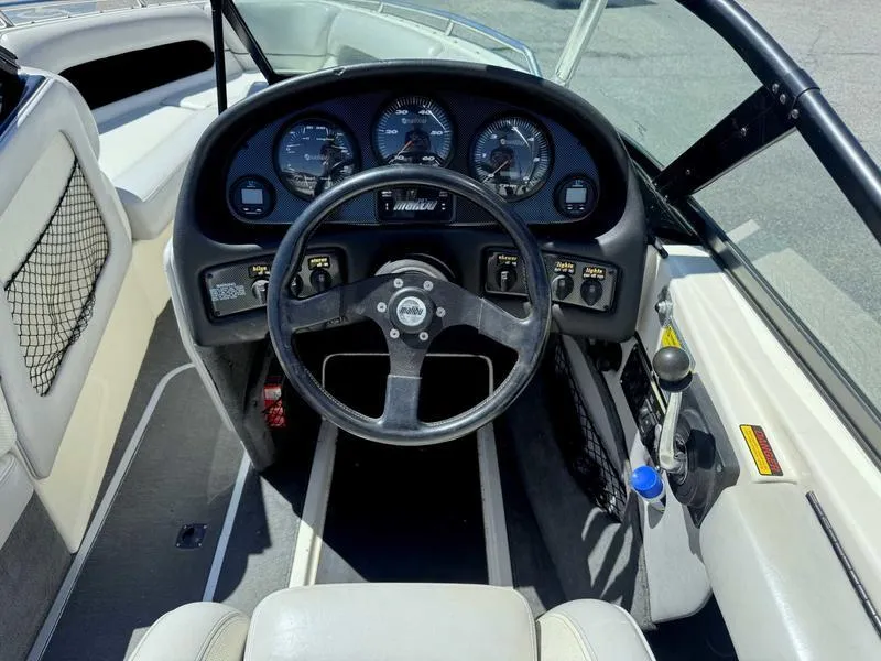 Slide: The Image of 1999 Malibu Sunsetter VLX boat dashboard with steering wheel and instrument panel. - 9