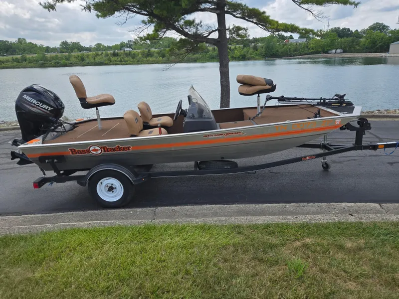 Slide: The Image of 2018 Tracker Bass Tracker 40th Anniversary Heritage Edition boat by a lake. - 10