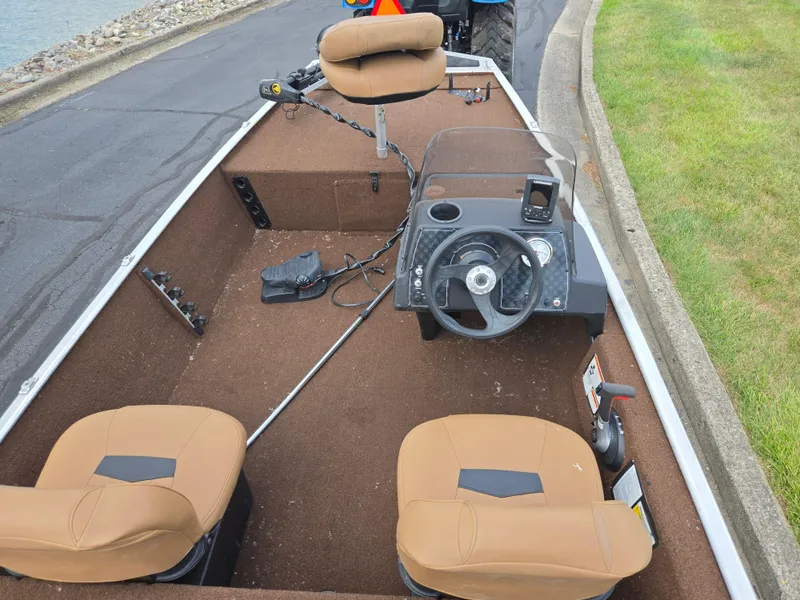 Slide: The Image of 2018 Tracker Bass Tracker 40th Anniversary Heritage Edition boat interior with tan seats and steering console. - 11