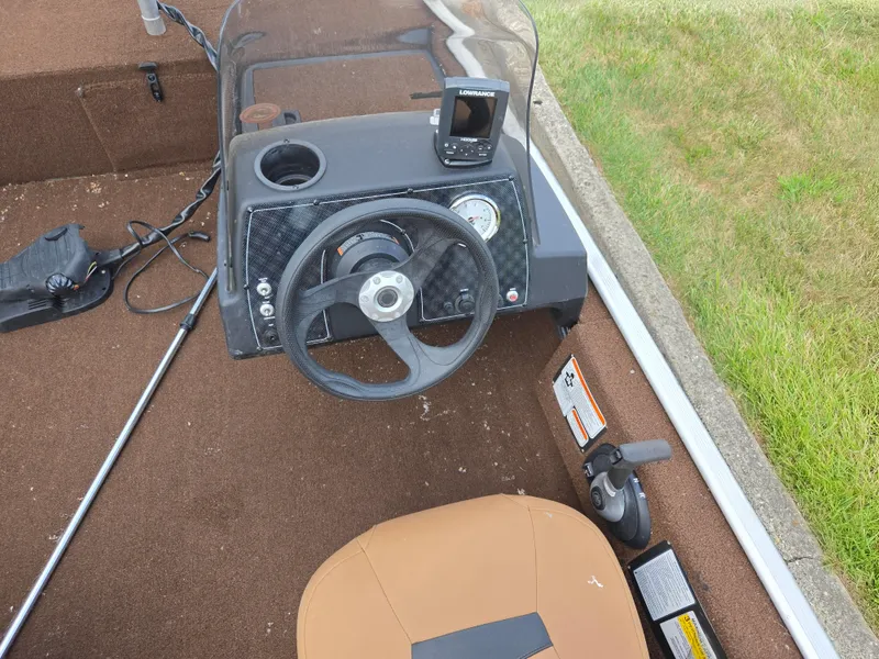 Slide: The Image of 2018 Tracker Bass Tracker 40th Anniversary Heritage Edition boat dashboard with steering wheel and controls. - 12