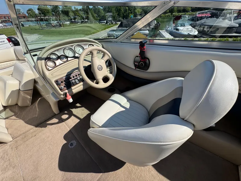 Slide: The Image of Interior of a 1999 Caravelle 209 Bow Rider boat with steering wheel and dashboard. - 10