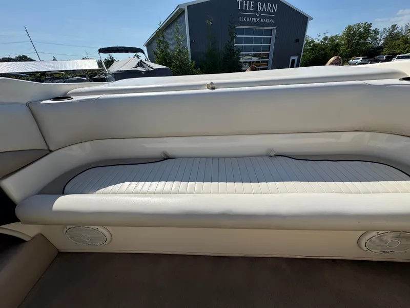 Slide: The Image of 1999 Caravelle 209 Bow Rider boat interior with white seating, located at Elk Rapids Marina. - 12