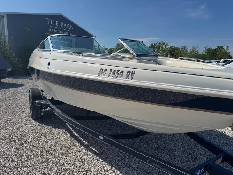 Slide: The Image of 1999 Caravelle 209 Bow Rider boat on trailer at Elk Rapids Marina. - 5