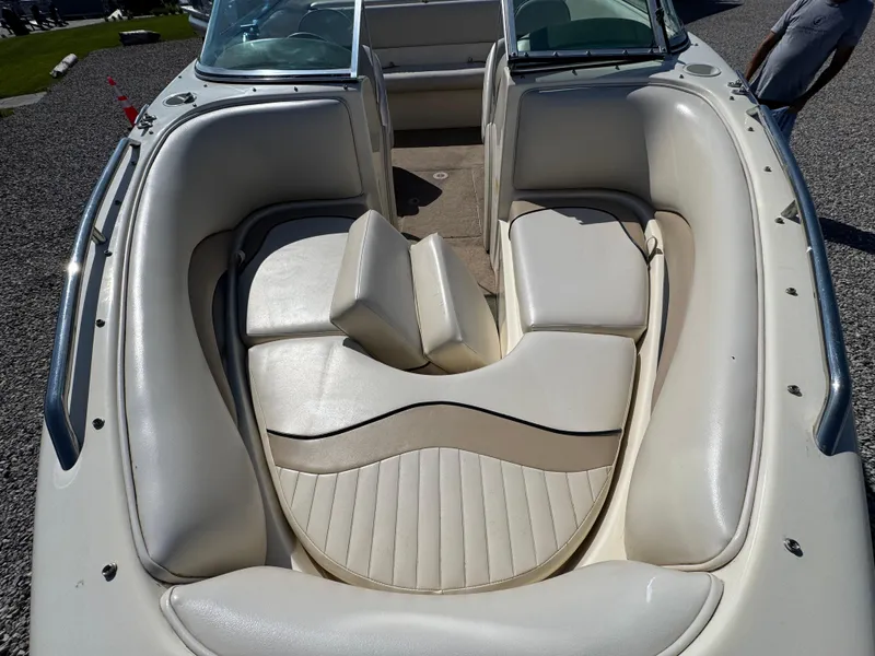 Slide: The Image of 1999 Caravelle 209 Bow Rider boat interior with white cushioned seating. - 9
