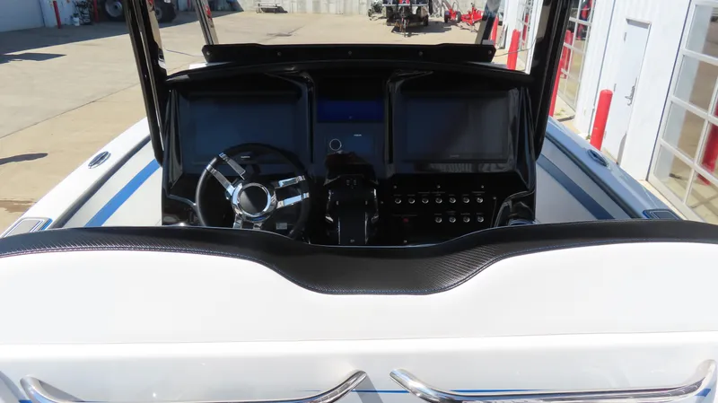 Slide: The Image of 2023 Sunsation 32 CCX boat dashboard with steering wheel and control panels. - 11