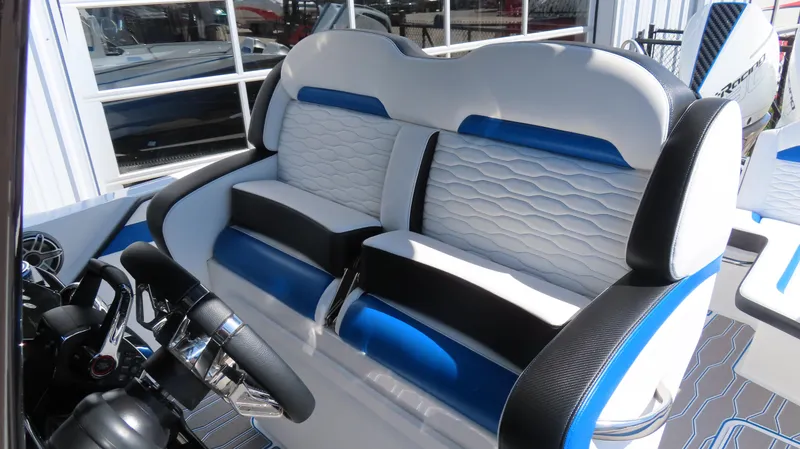 Slide: The Image of 2023 Sunsation 32 CCX boat interior with stylish blue and white seating and modern steering wheel. - 13