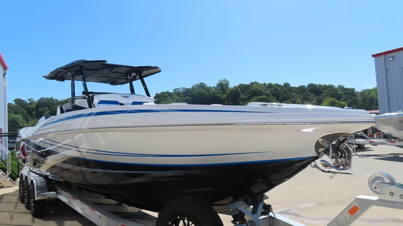 Slide: The Image of 2023 Sunsation 32 CCX boat on trailer, sleek design, outdoors, sunny day. - 5