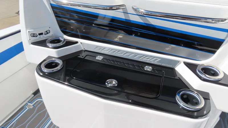 Slide: The Image of 2023 Sunsation 32 CCX boat interior with cup holders and sleek design. - 9