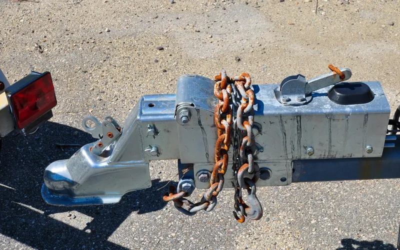 Slide: The Image of Trailer hitch with rusted chains on a 2002 Pursuit 2470 Walkaround boat trailer. - 45