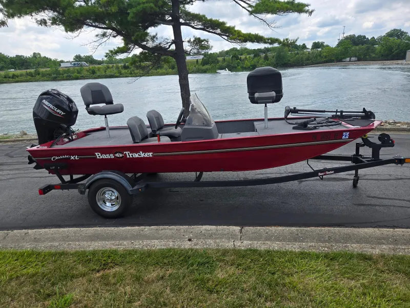 Slide: The Image of 2024 Tracker Bass Tracker Classic XL boat on trailer by a river. - 10