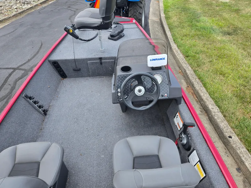 Slide: The Image of 2024 Tracker Bass Tracker Classic XL boat interior with steering wheel and seats. - 11