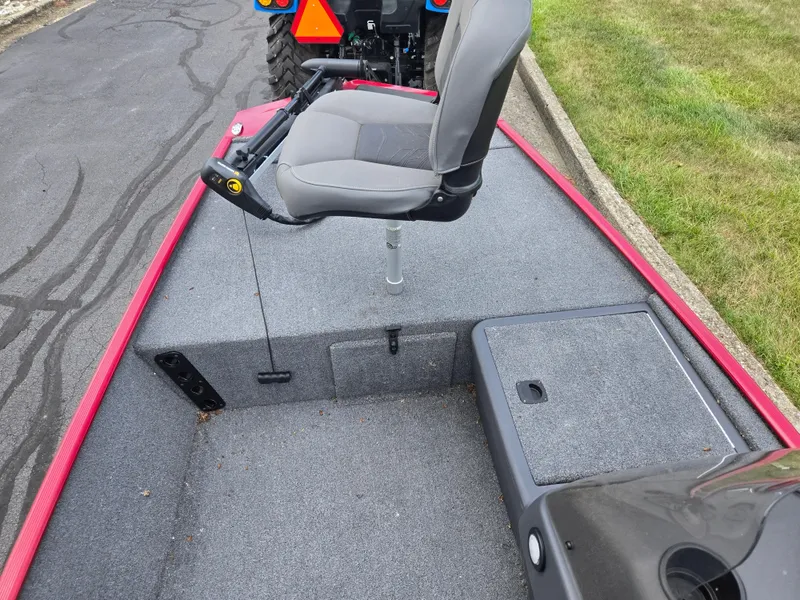 Slide: The Image of 2024 Tracker Bass Tracker Classic XL boat interior with gray seating and carpeted deck. - 13