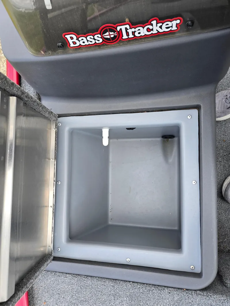 Slide: The Image of 2024 Tracker Bass Tracker Classic XL livewell with open lid, showcasing interior space. - 14