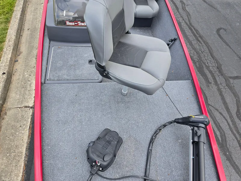 Slide: The Image of 2024 Tracker Bass Tracker Classic XL boat interior with gray seats and trolling motor. - 16