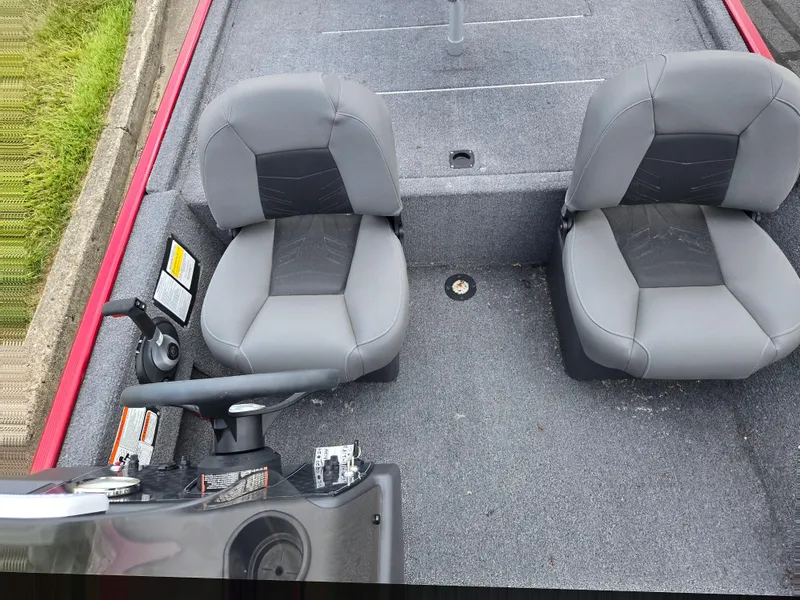 Slide: The Image of 2024 Tracker Bass Tracker Classic XL boat interior with two gray seats and steering console. - 18