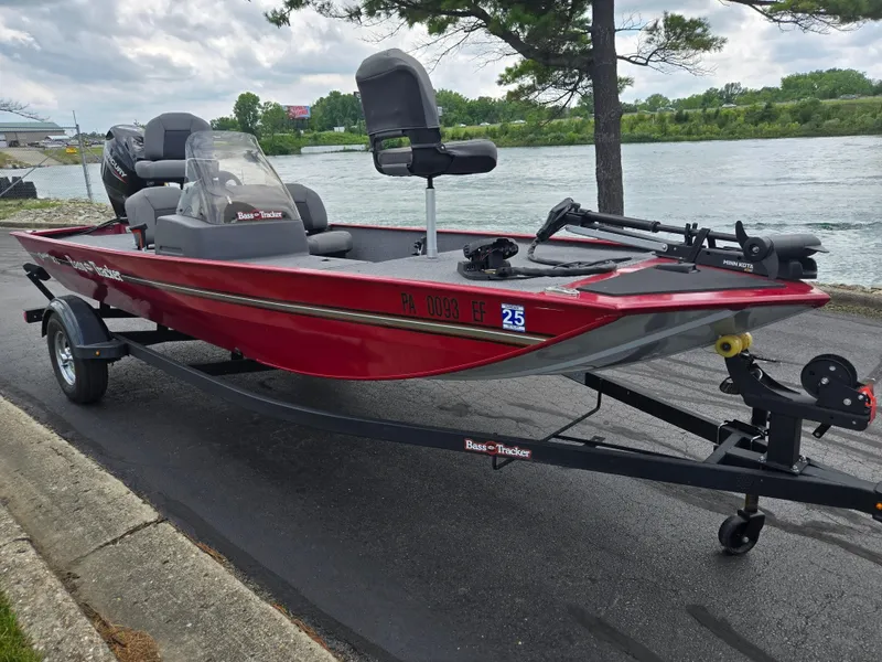 Slide: The Image of 2024 Tracker Bass Tracker Classic XL boat on trailer by a river. - 9