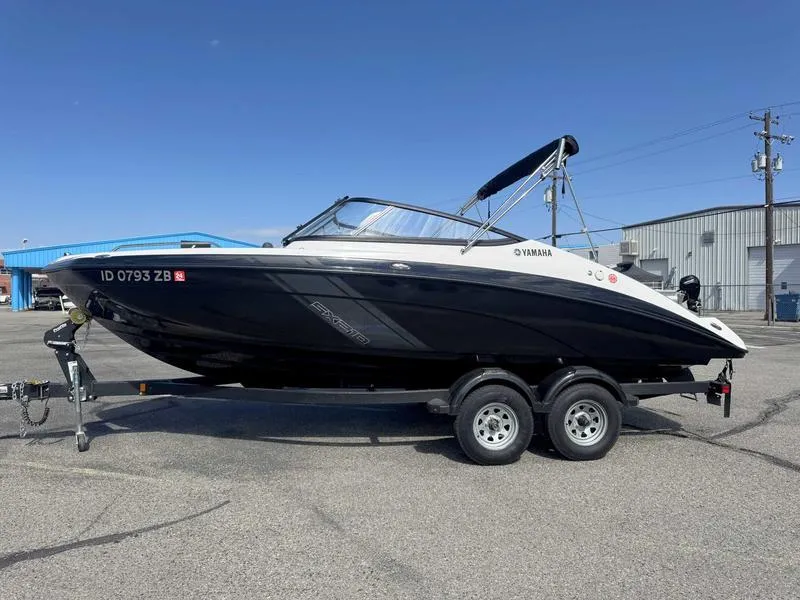 Slide: The Image of 2022 Yamaha SX210 boat on trailer, parked outdoors under clear blue sky. - 1