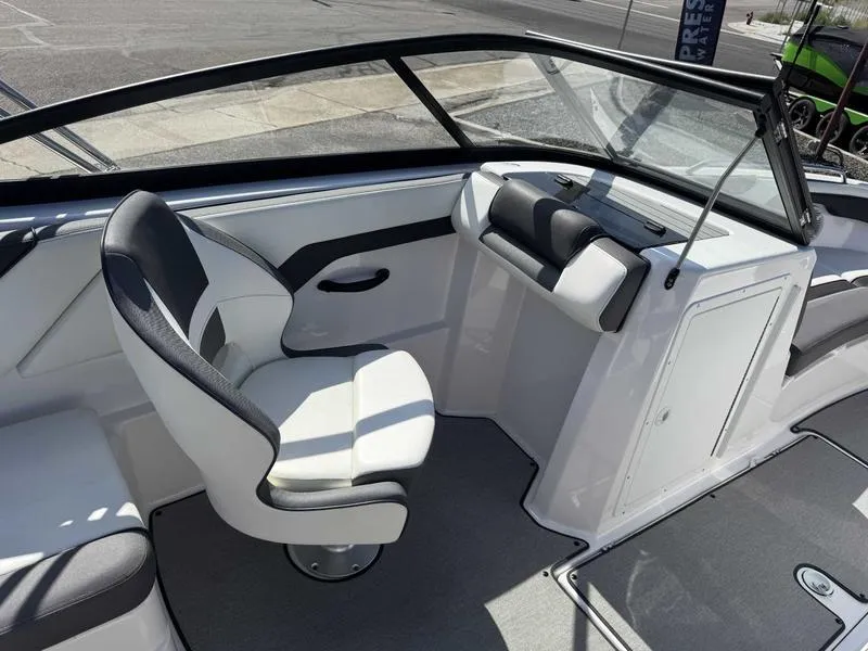 Slide: The Image of 2022 Yamaha Boats SX210 interior with white seating and modern design. - 10