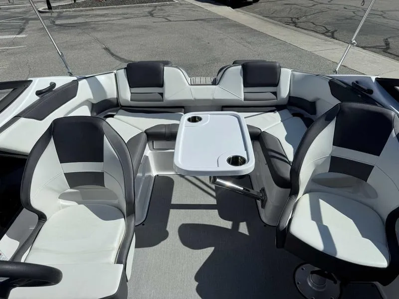Slide: The Image of 2022 Yamaha Boats SX210 interior with seating and table, featuring modern design and cup holders. - 11