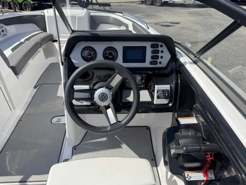 Slide: The Image of 2022 Yamaha Boats SX210 dashboard with steering wheel and control panel. - 12