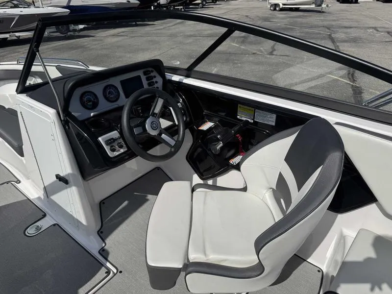 Slide: The Image of 2022 Yamaha Boats SX210 cockpit with steering wheel and controls, featuring modern design. - 13