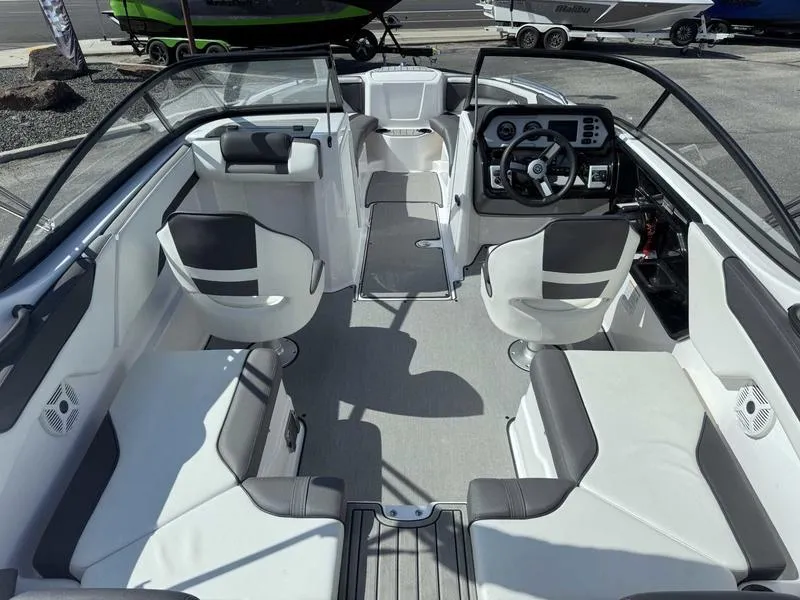 Slide: The Image of 2022 Yamaha Boats SX210 interior with modern seating and steering console. - 14