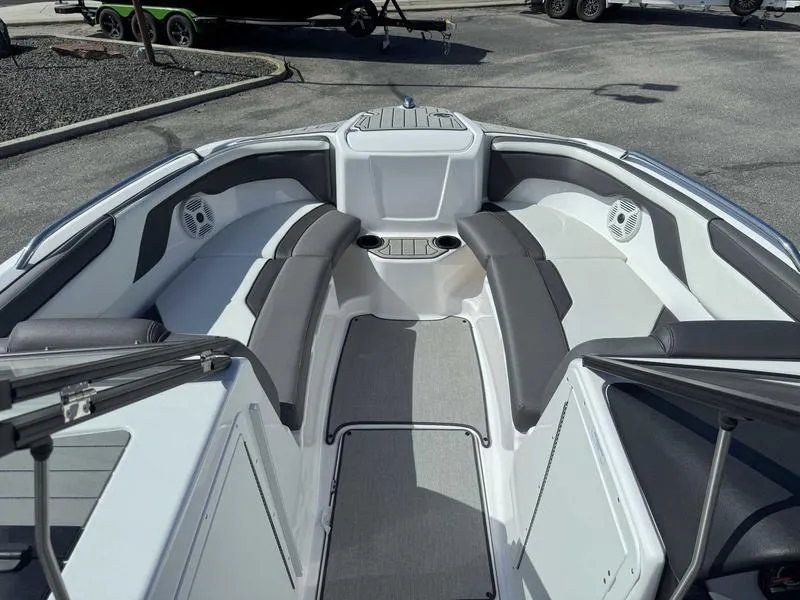 Slide: The Image of 2022 Yamaha Boats SX210 interior with gray seating and cup holders. - 15