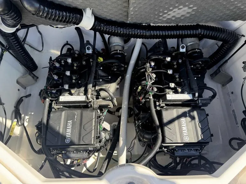 Slide: The Image of 2022 Yamaha SX210 boat engine compartment with dual engines and wiring. - 2