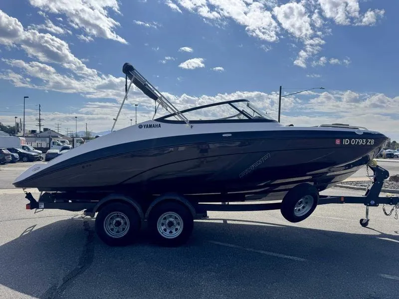 Slide: The Image of 2022 Yamaha SX210 boat on trailer under a partly cloudy sky. - 5