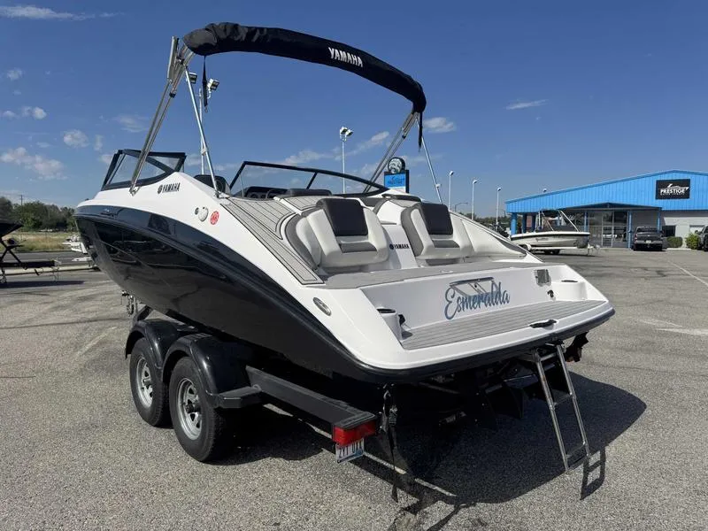 Slide: The Image of 2022 Yamaha SX210 boat on trailer, parked outdoors under clear blue sky. - 7